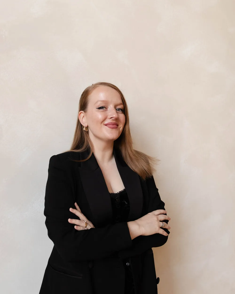A Moxie agent standing with her arms crossed.
